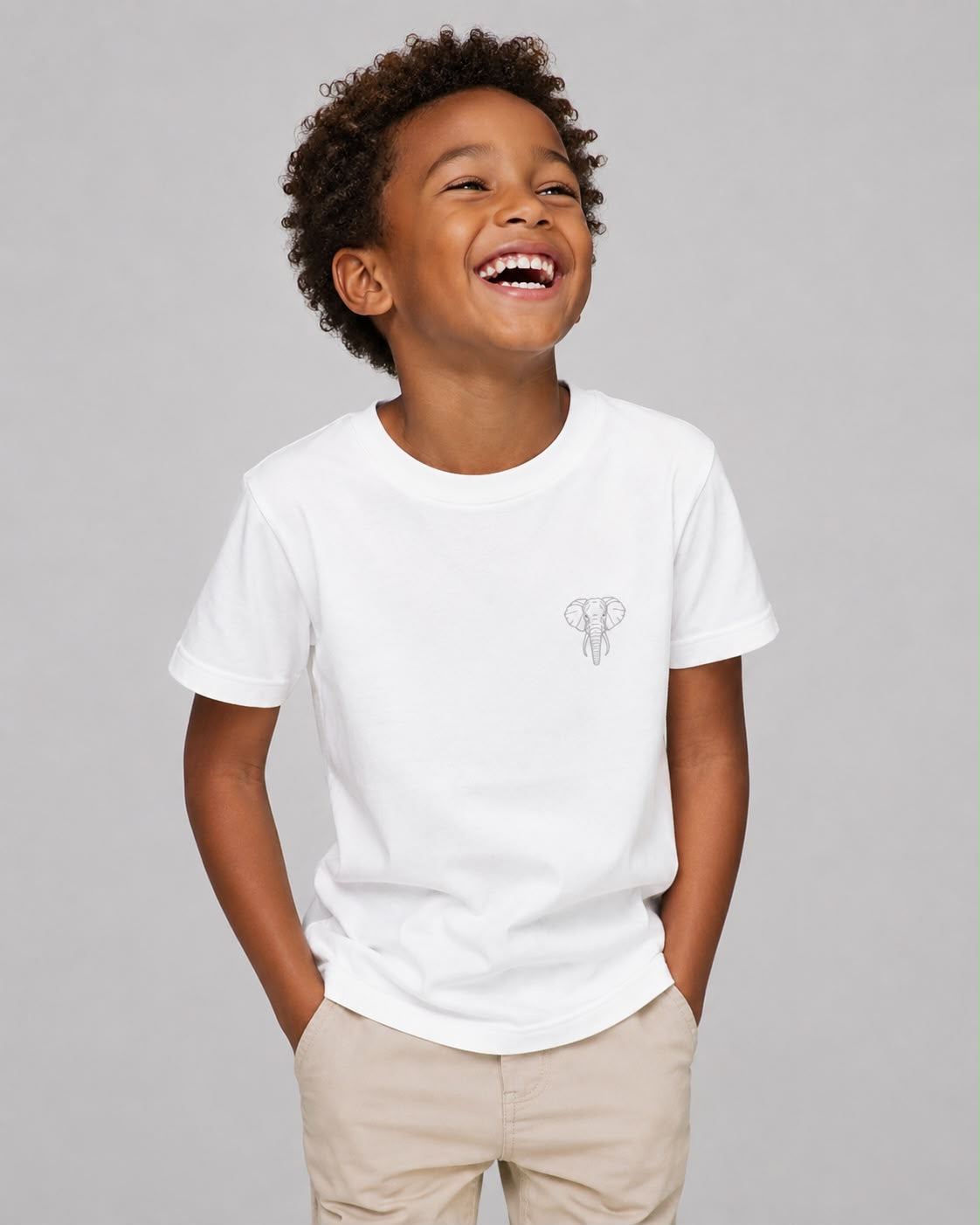 Child wearing a white t-shirt with a small logo on a gray background